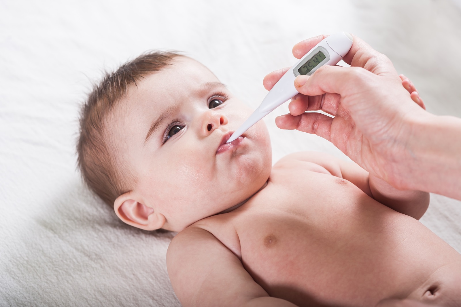 Picture of a baby with a thermometer in its mouth